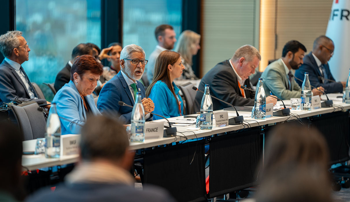 Attendees from various countries listening to a presentationin a conference room
